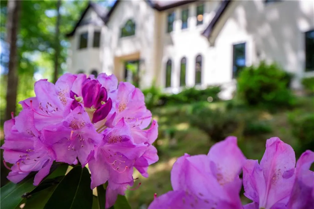 Seasonal blooms add color and charm, enhancing the home’s inviting curb appeal.