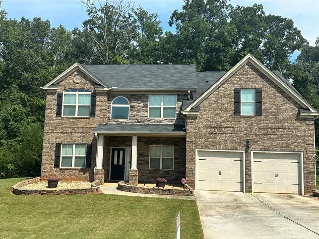 Brick exterior with a dark-pitched roof