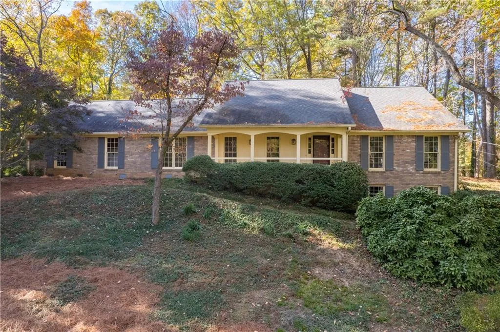 Welcoming front porch on this four-sided brick home!