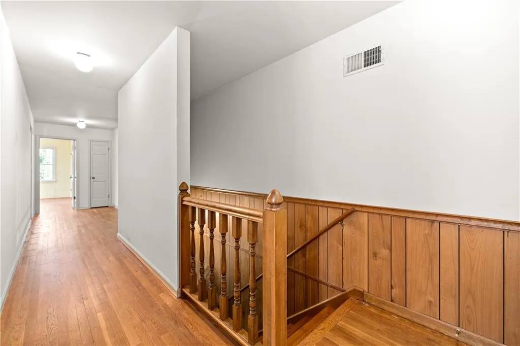 Upstairs hallway also includes newly uncovered hardwood floors