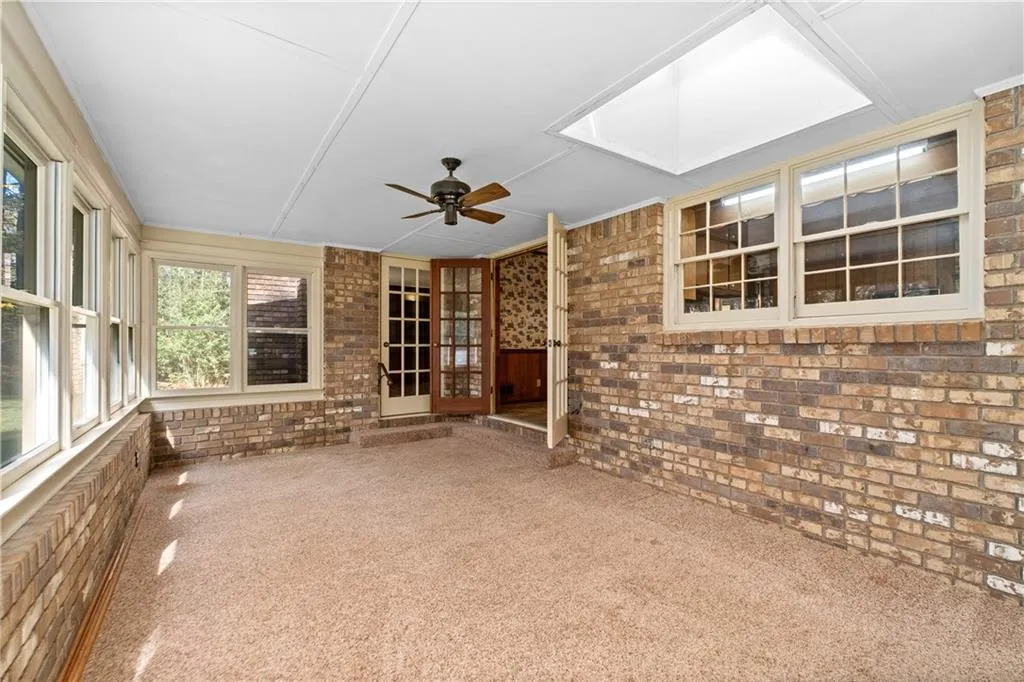 Sunroom off family room and kitchen includes a bright sky light, newer double paned windows.