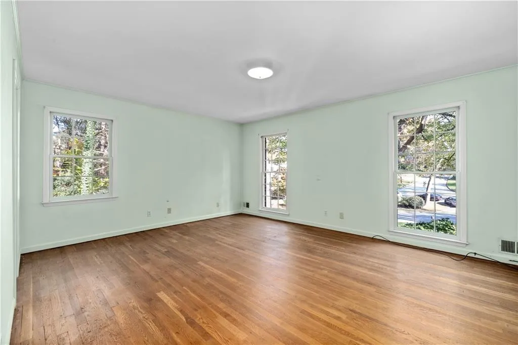 Master bedroom with multiple windows, hardwood floors