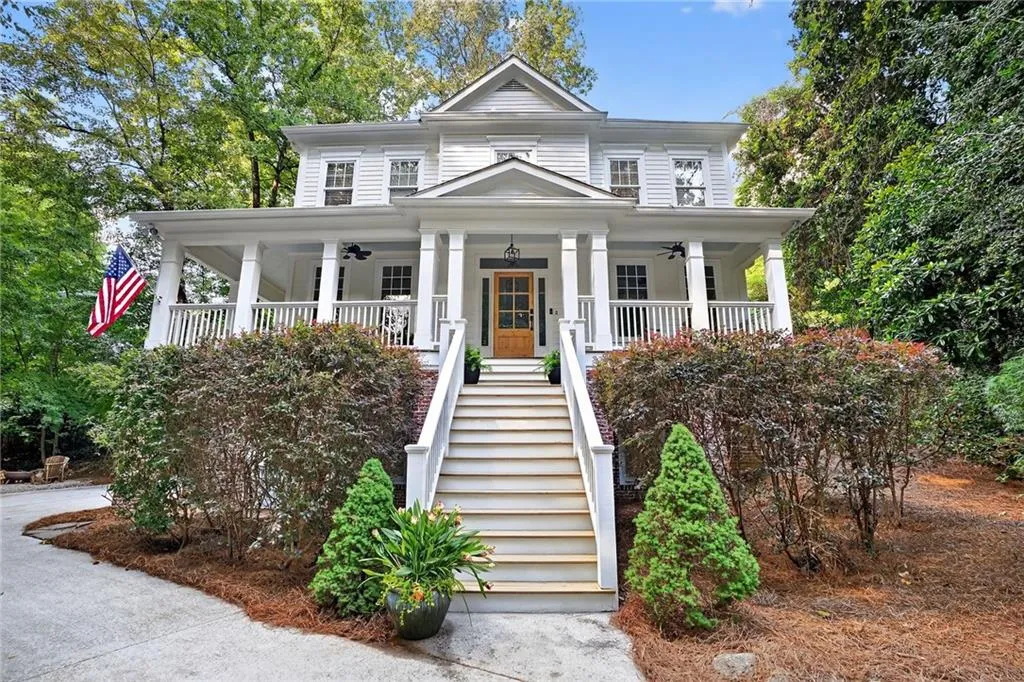 View of front of house with stairs and a porch