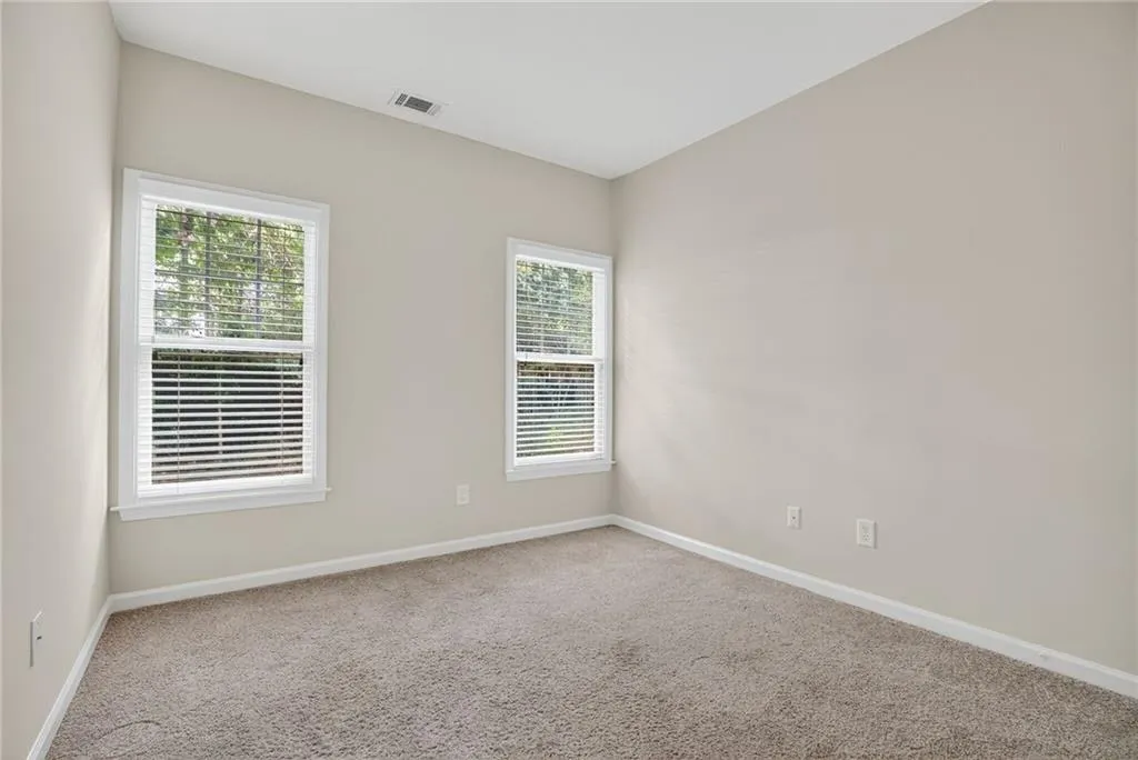 Carpeted spare room with baseboards