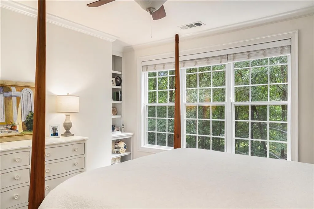 Bedroom lets nature in through privacy windows.