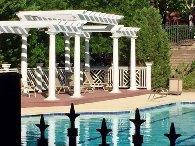Community pool with a patio and a pergola
