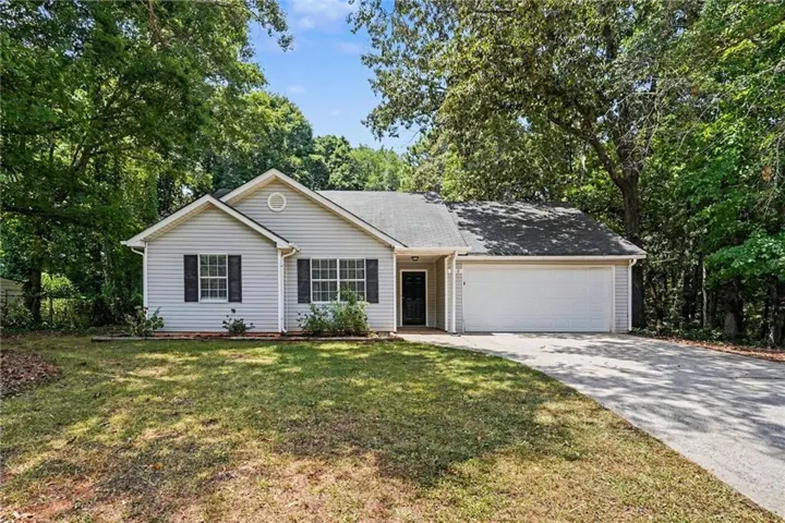 Ranch-style exterior with light gray siding and dark shutters