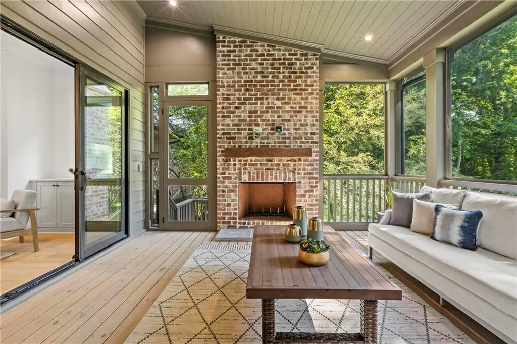 Sunroom / solarium with an outdoor living space with a fireplace and vaulted ceiling