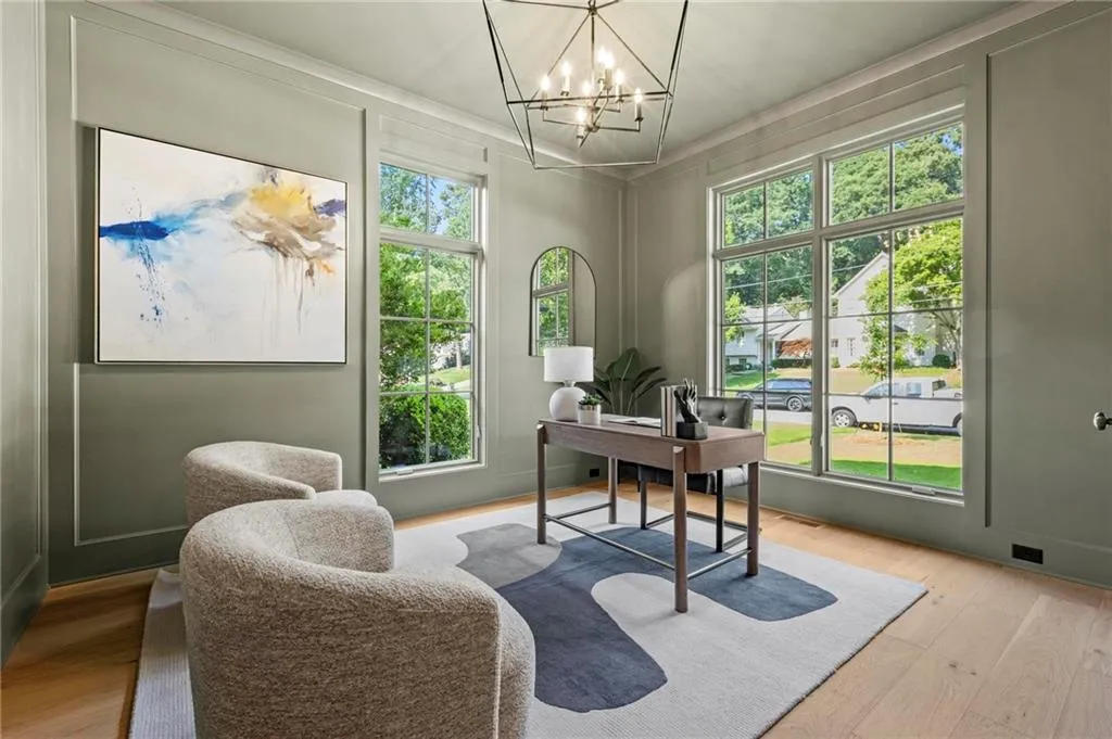 Main level office/study with floor to ceiling windows, closet for electronics