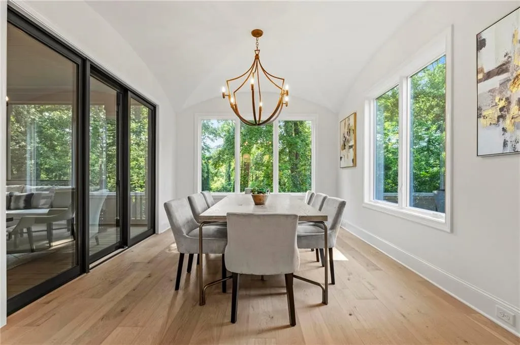 Open dining w/groin vaulted ceiling, overlooks screen porch and kitchen