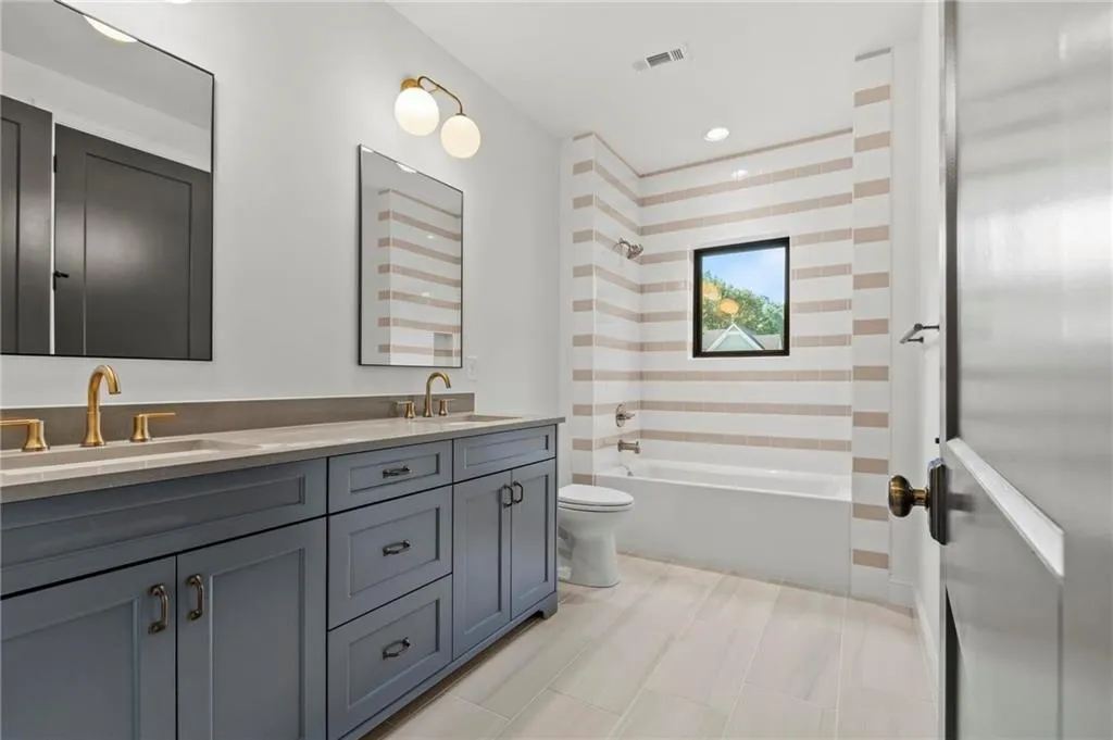 Full bathroom with double vanity and  shower combination