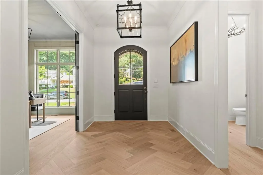 Entrance hall with chandelier, custom heavy front door