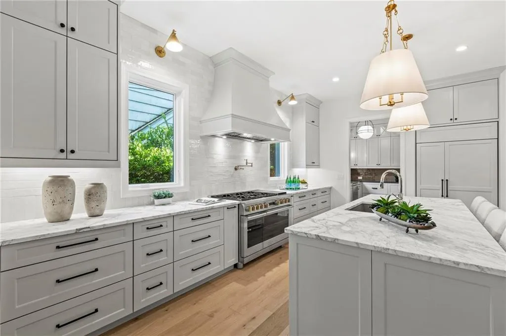 Kitchen featuring paneled appliances, marble