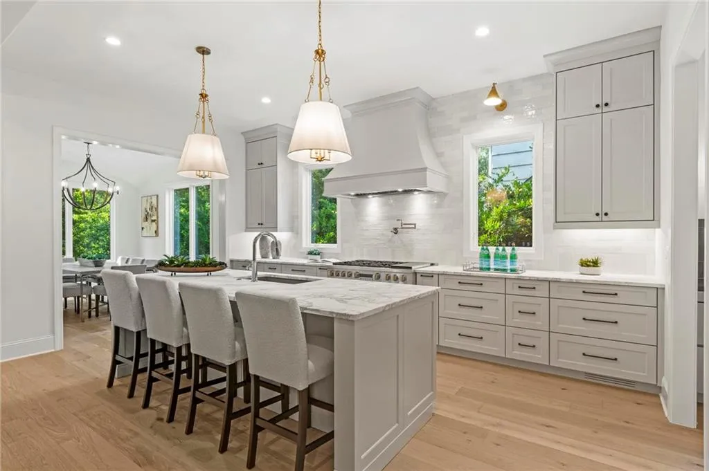 Kitchen featuring custom range hood & cabinetry, paneled appliances, Scullery next door