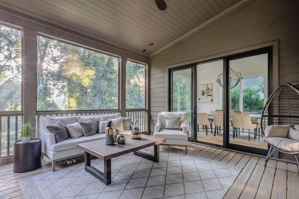 Sunroom / solarium with vaulted ceiling, hardwood / wood-style flooring, an outdoor living space, a deck, and wood ceiling