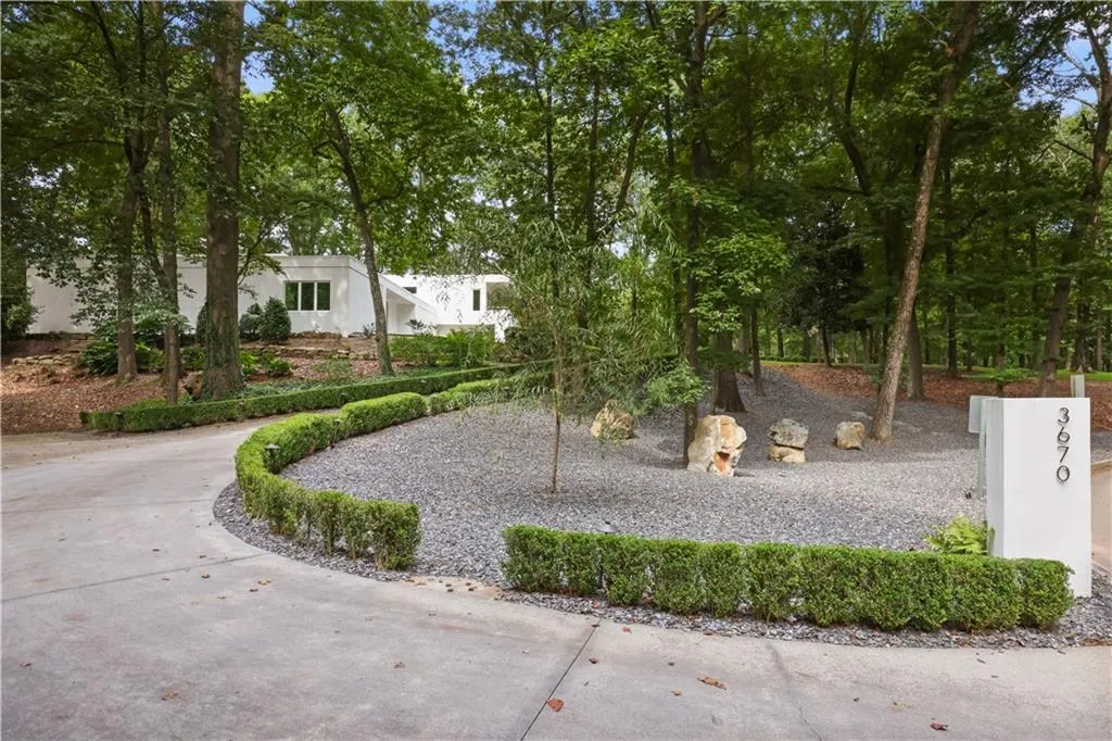 Driveway includes a lower parking pad.