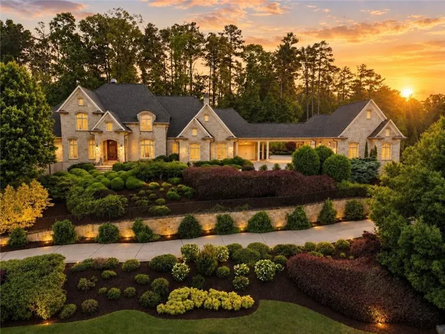 Stone exterior with multiple gables and a dark shingle roof