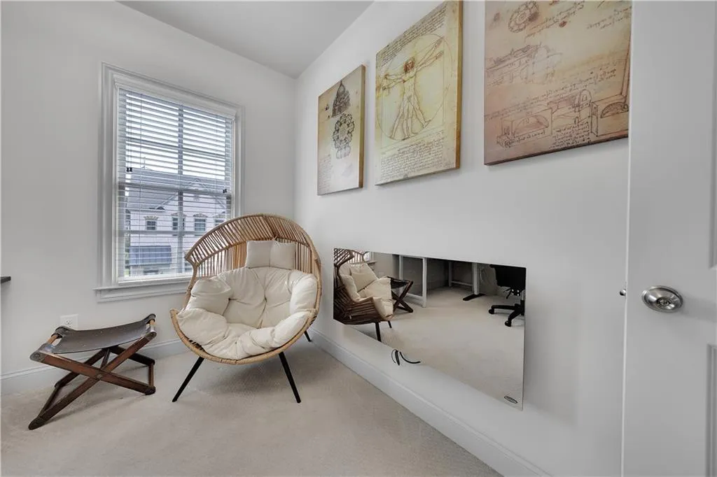 Sitting room featuring carpet floors and baseboards