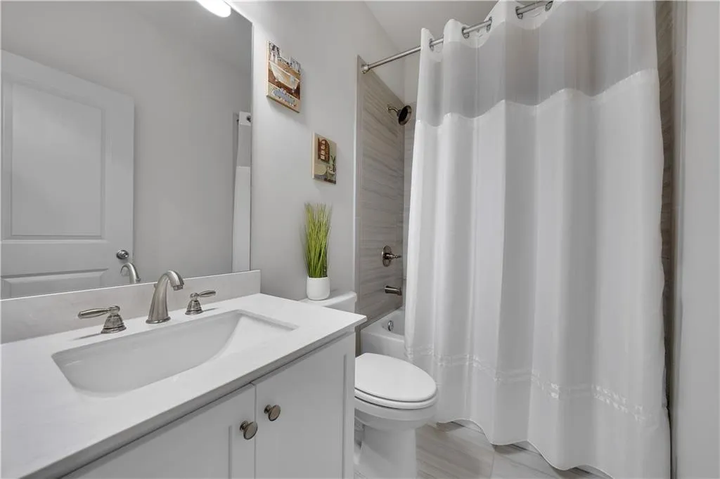 Full bathroom with vanity and shower / bath combo with shower curtain