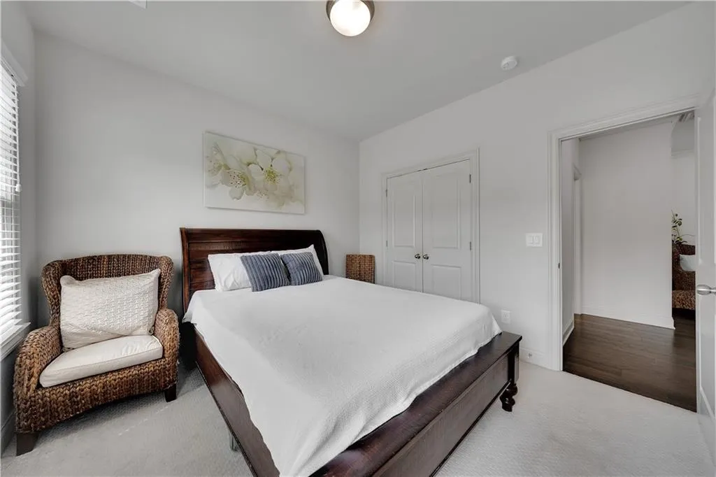Carpeted bedroom featuring a closet and baseboards