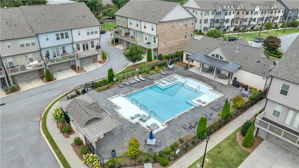 Aerial perspective of suburban area featuring a pool area