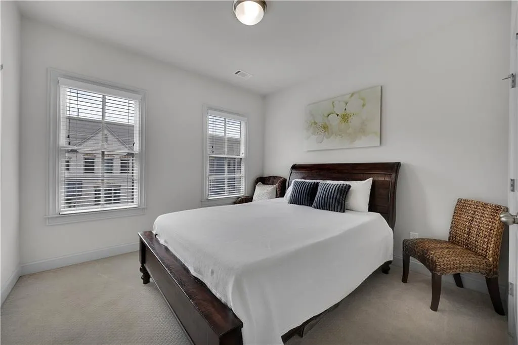 Bedroom featuring light carpet and baseboards