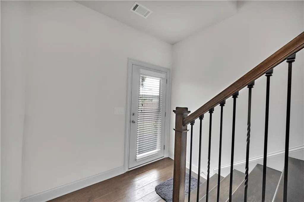 Entryway with stairs and dark wood finished floors