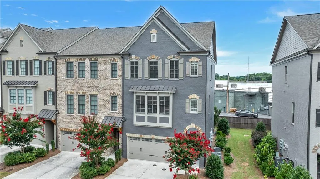 View of front of house featuring brick siding, driveway, and an attached garage