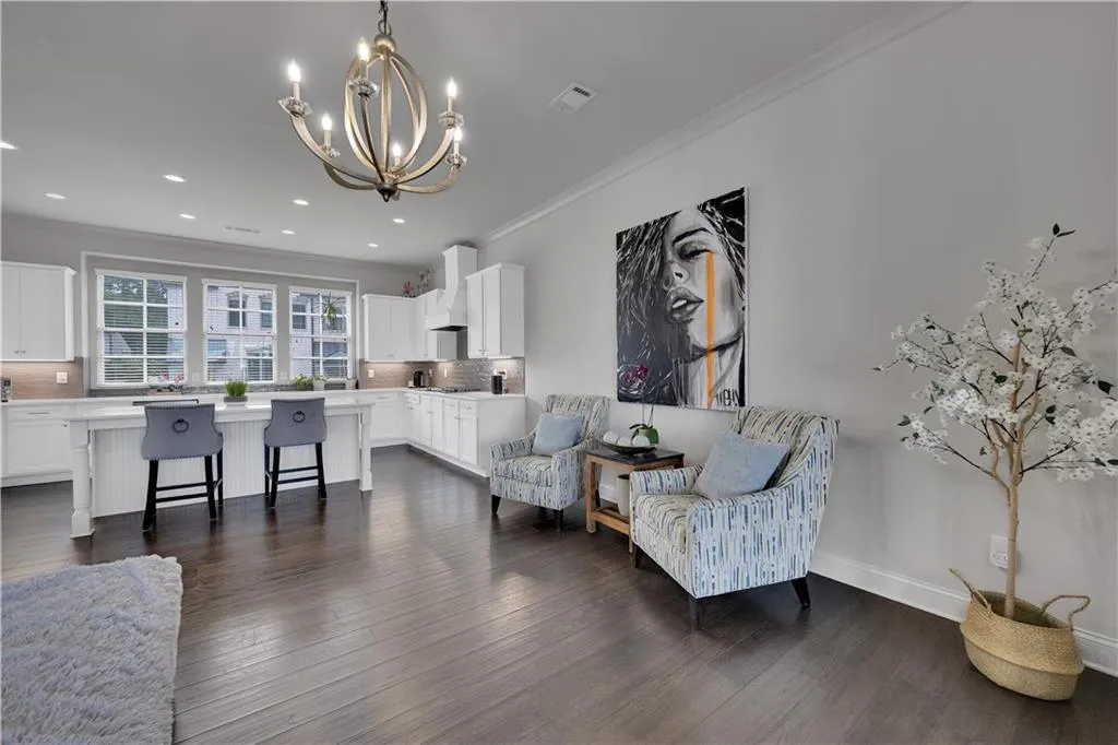 Sitting room featuring ornamental molding, a chandelier, dark wood-style flooring, and recessed lighting