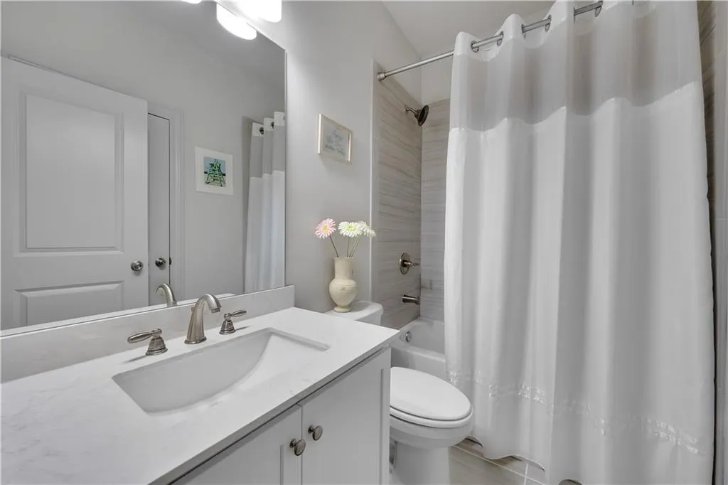 Full bathroom featuring vanity and shower / bathtub combination with curtain