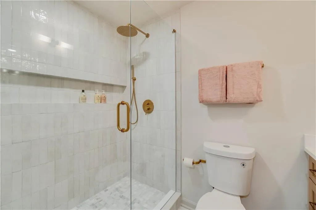 Bathroom with walk in shower, vanity, and toilet