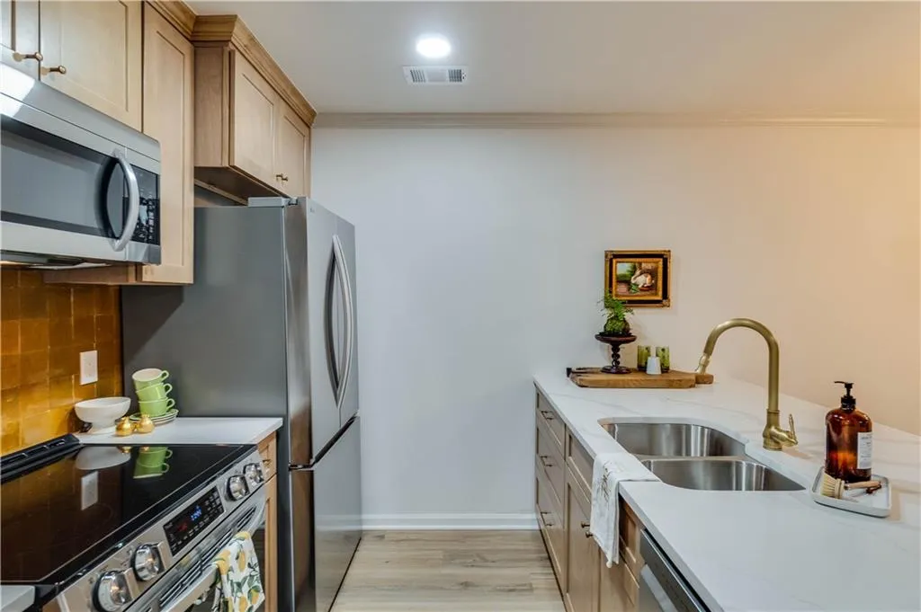 Kitchen featuring large island and new appliances
