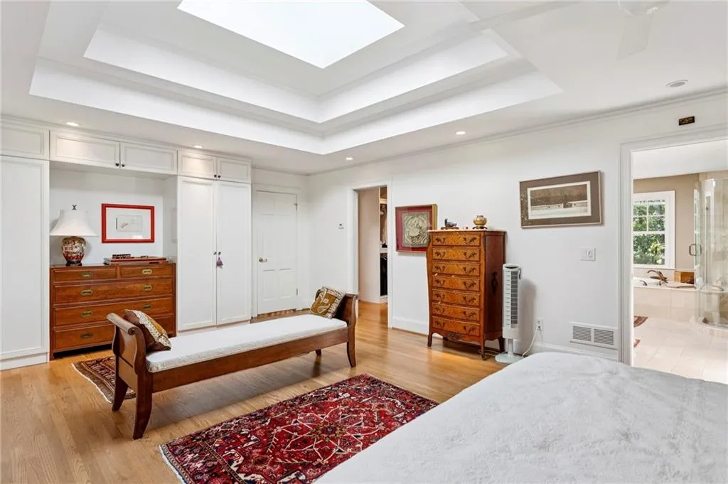 Dramatic tray ceilng and skylight in the primary bedroom