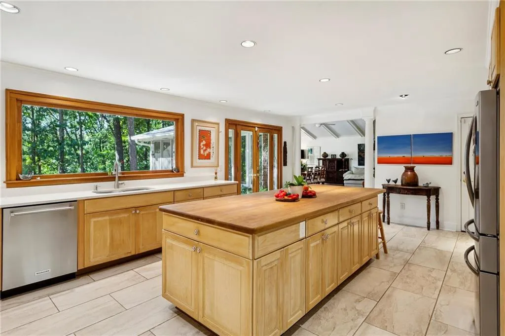 Large window and glass doors bring the outside in