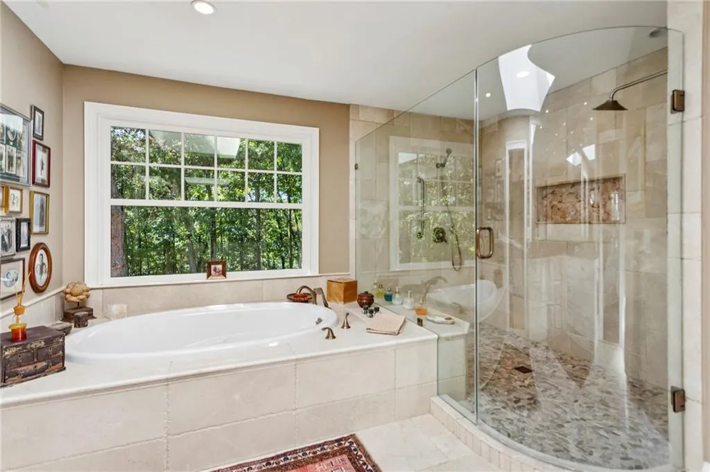 Primary bath with soaking tub and large frameless shower with multiple showerheads