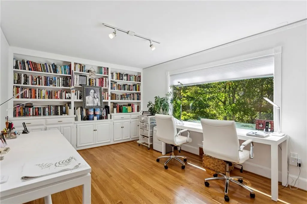 Light, bright office with a huge window and built-ins