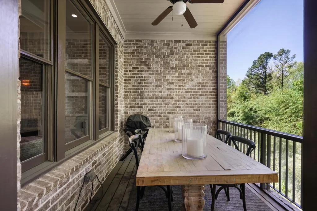 Balcony with a ceiling fan and outdoor dining area