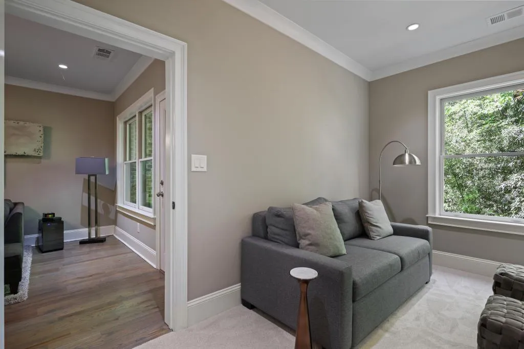 Living room featuring ornamental molding, recessed lighting, and wood finished floors