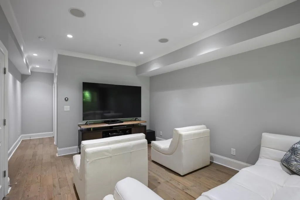Living room with recessed lighting, light wood-style flooring, and ornamental molding