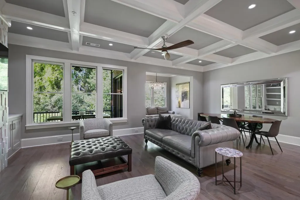 Living room featuring ceiling fan, recessed lighting, coffered ceiling, and dark wood-style flooring