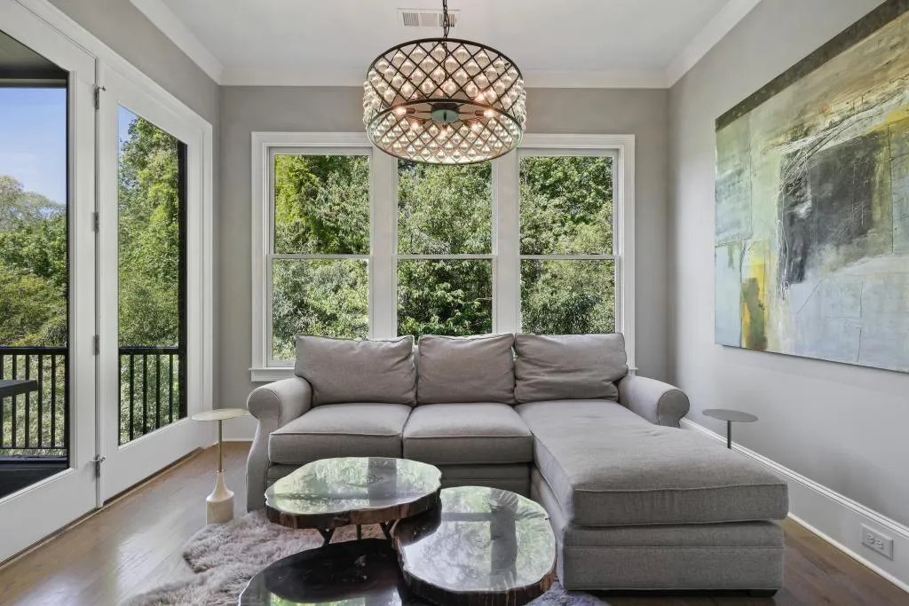 Sunroom / solarium with wood finished floors and ornamental molding