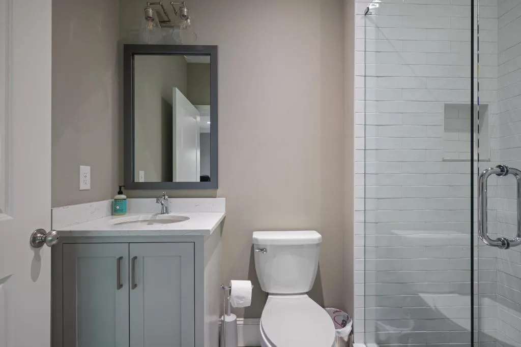 Full bath featuring vanity and a shower stall