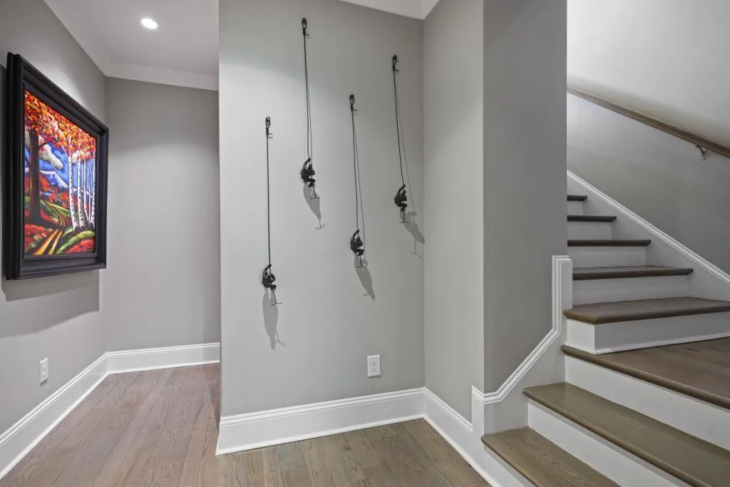 Stairway featuring wood finished floors and recessed lighting