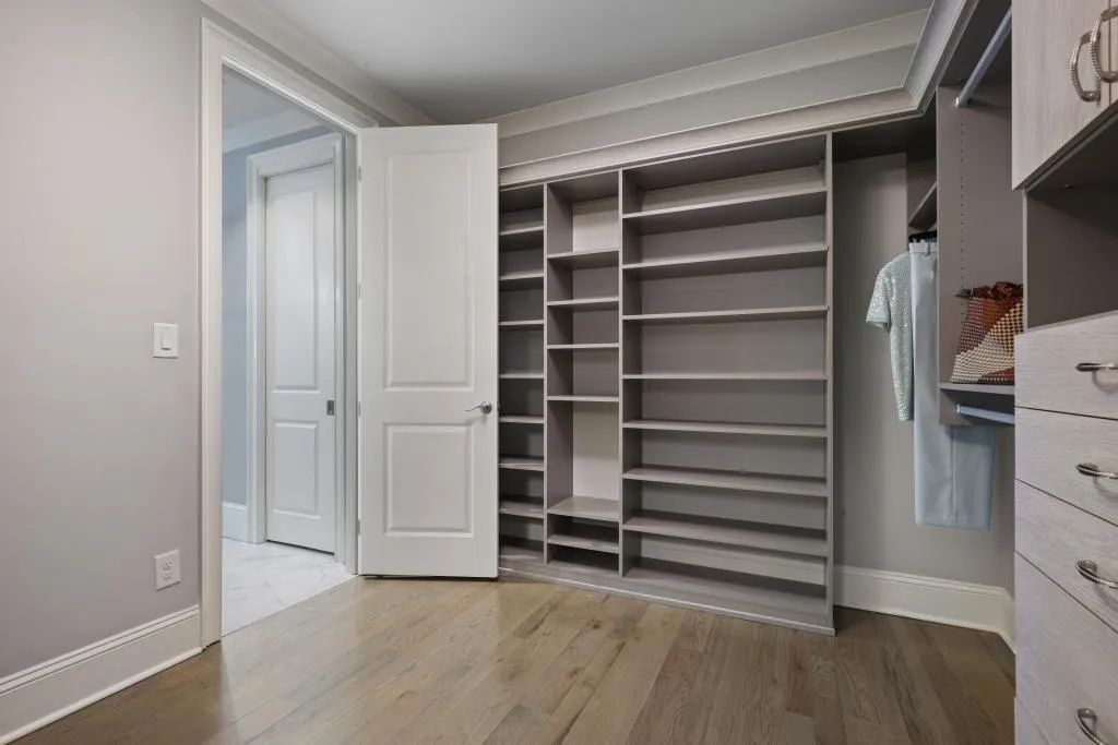 Walk in closet featuring light wood-style flooring