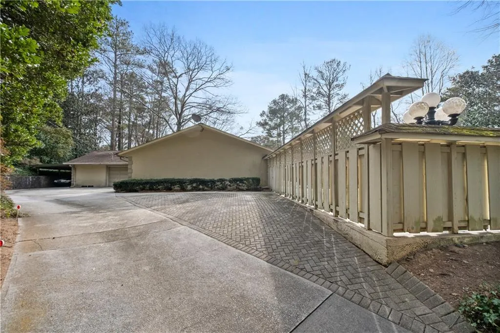 View of home's exterior with driveway and a garage