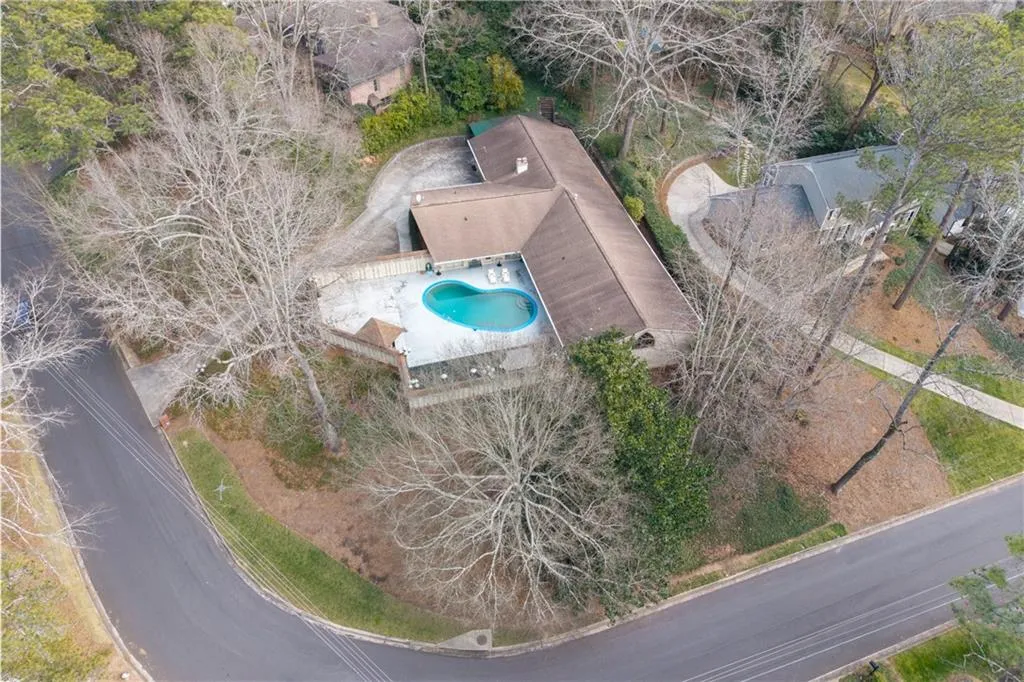 Bird's eye view of a pool and a tree filled landscape