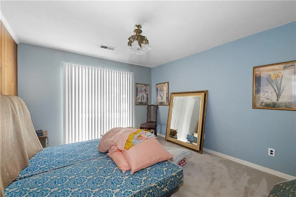 Carpeted bedroom featuring baseboards