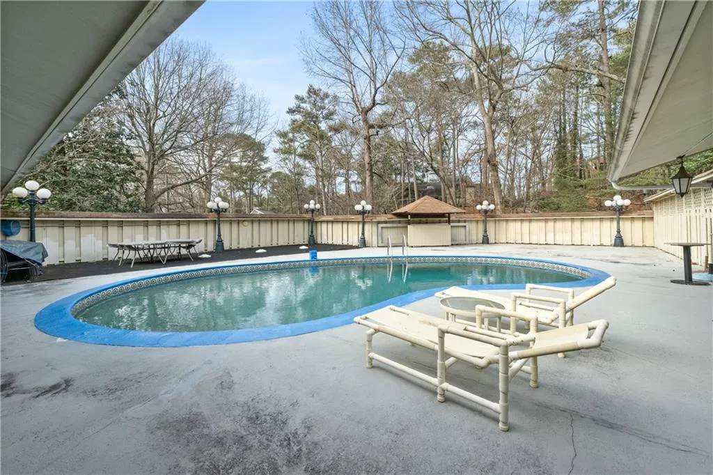 View of pool with a fenced backyard and a patio