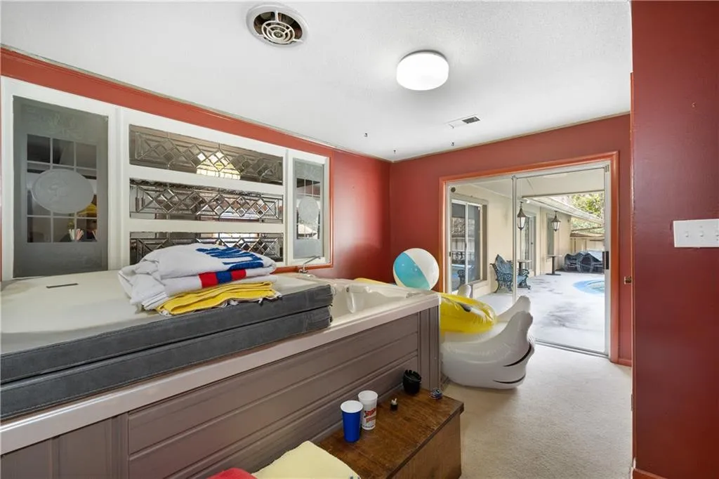 Bedroom with light colored carpet and access to outside