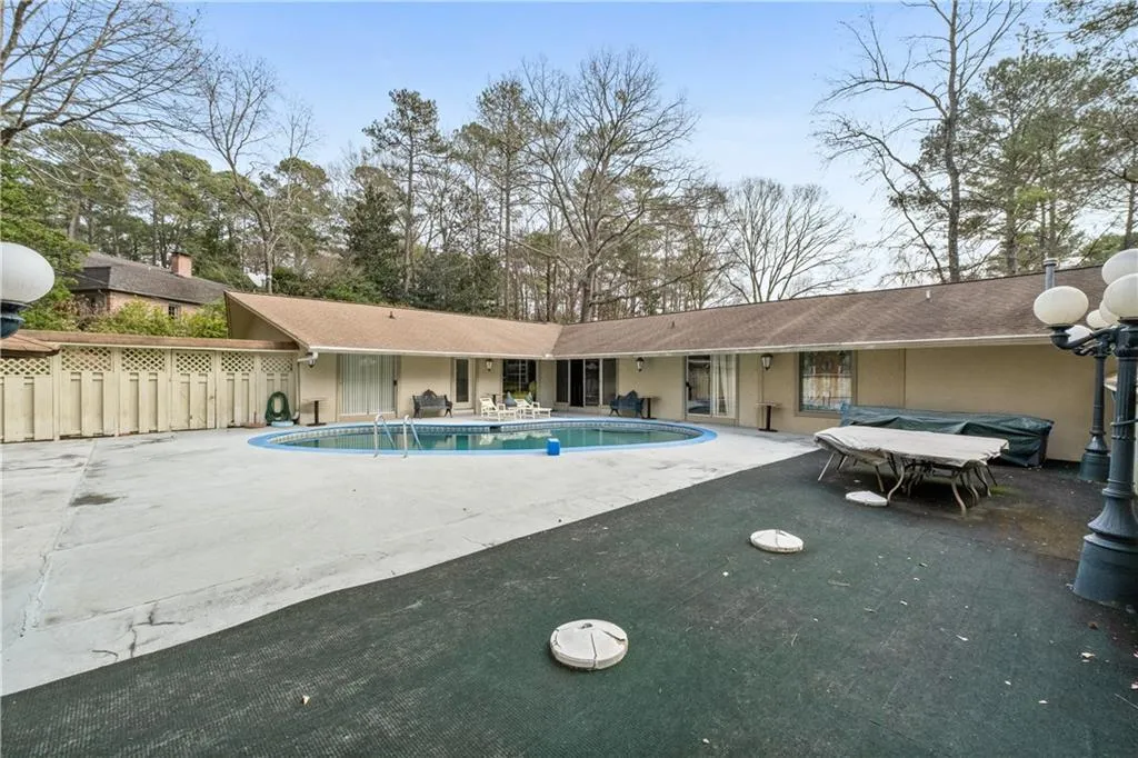 View of swimming pool with a patio and outdoor dining space